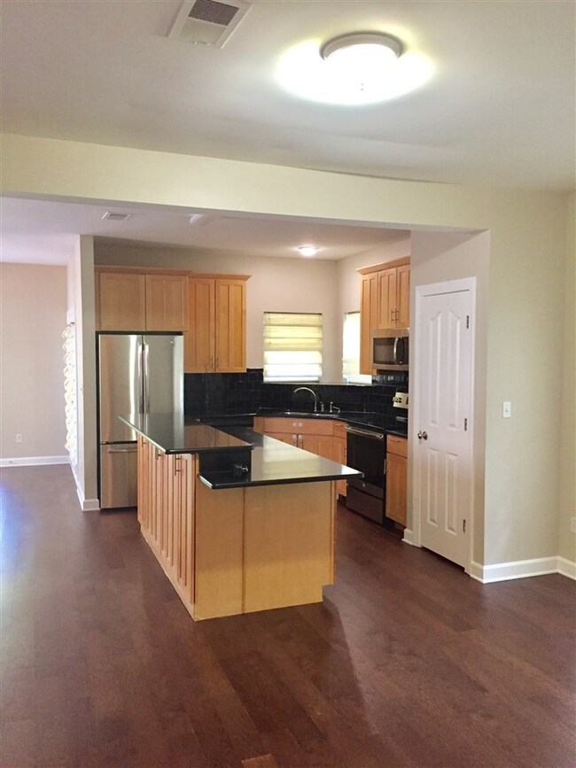 OPEN PLAN VIEW OF KITCHEN FROM DINING