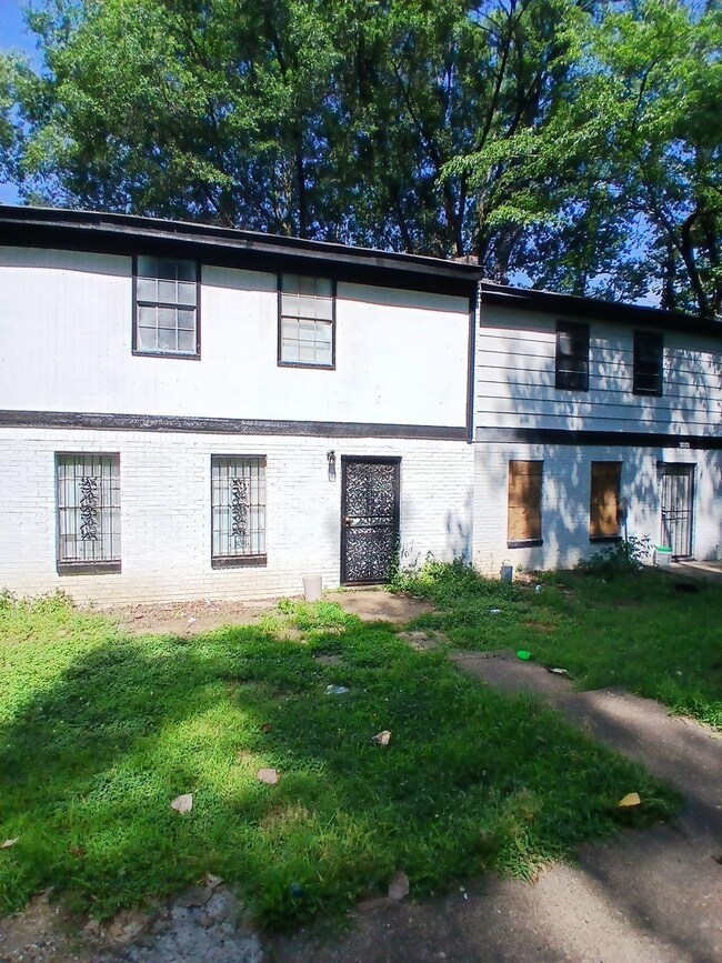 View of front of home featuring brick siding and a front lawn