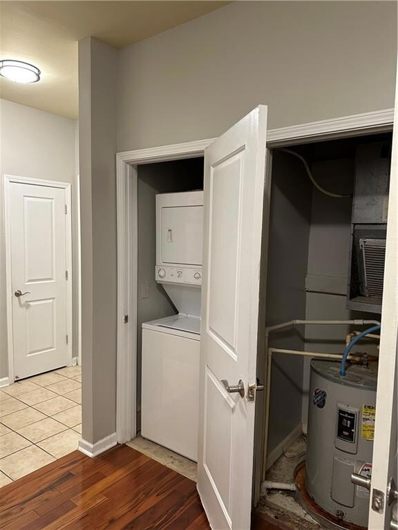 Laundry area with water heater, stacked washer and