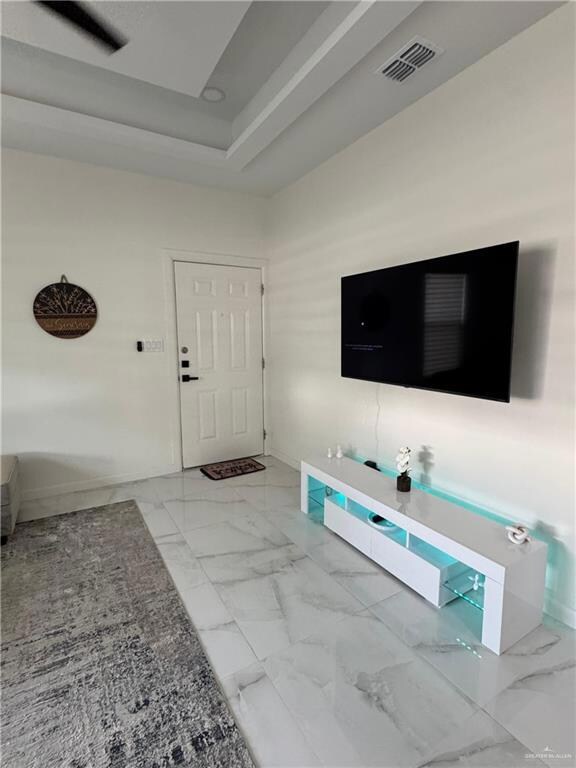 Living area featuring marble look tile flooring