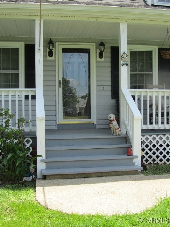View of exterior entry featuring a porch