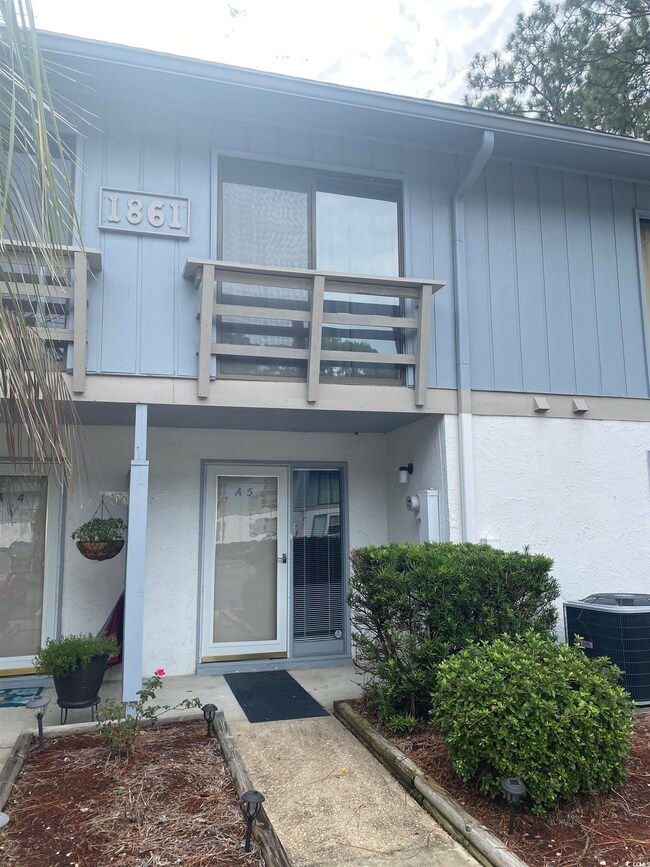 Entrance to property with a balcony and central air condition unit