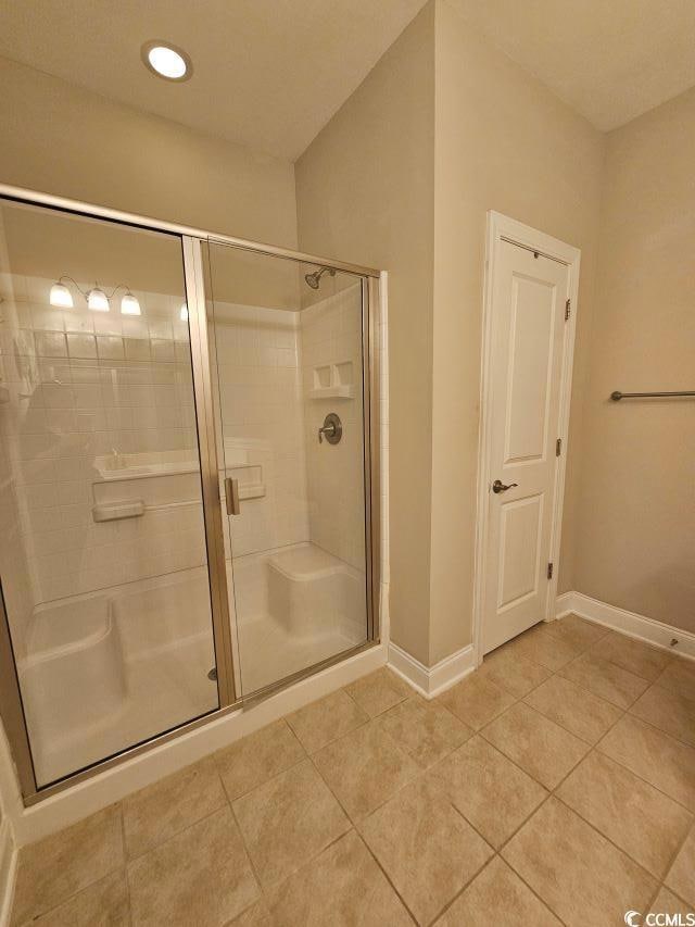 Bathroom with tile patterned floors and walk in sh