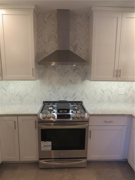 More kitchen with new stove and under cabinet ligh