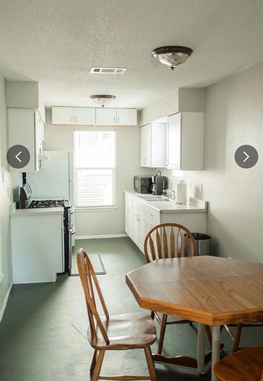 Dining area featuring a textured ceiling and base