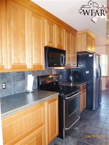 Left side of kitchen with maple custom cabinetry a