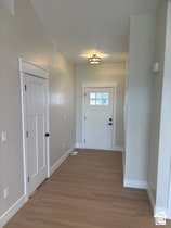 Entrance foyer featuring wood finished floors and baseboards