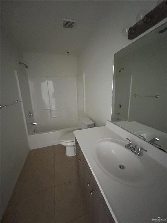 Bathroom featuring vanity, tile patterned flooring, and bathing tub / shower combination
