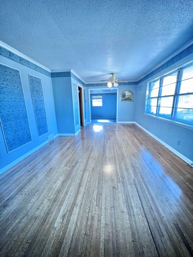 Unfurnished living room featuring ornamental moldi