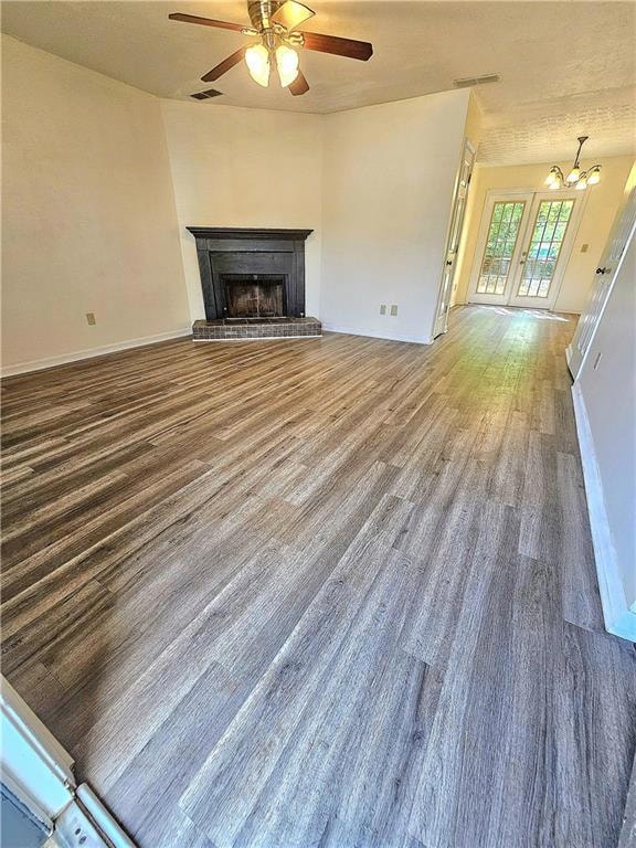 Unfurnished living room featuring ceiling fan with