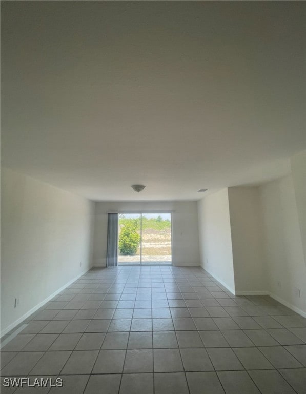 Empty room featuring light tile patterned flooring