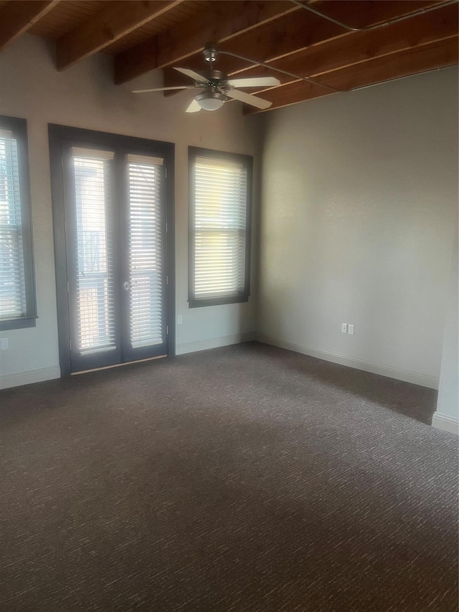Living room featuring beam ceiling, ceiling fan, f