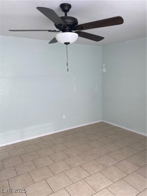 Empty room with ceiling fan and a textured ceiling