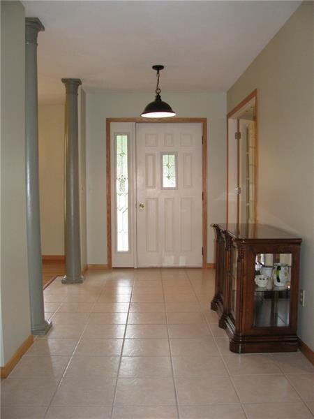 FORMAL FOYER WITH TILE FLOORING AND FLOOR TO CEILI