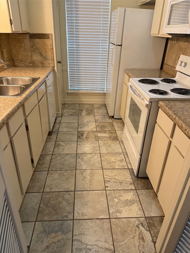 Kitchen with backsplash, range, dishwasher, microwave and range oven
