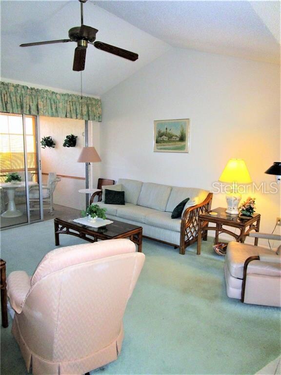 Living Room has carpeted flooring, cathedral ceili