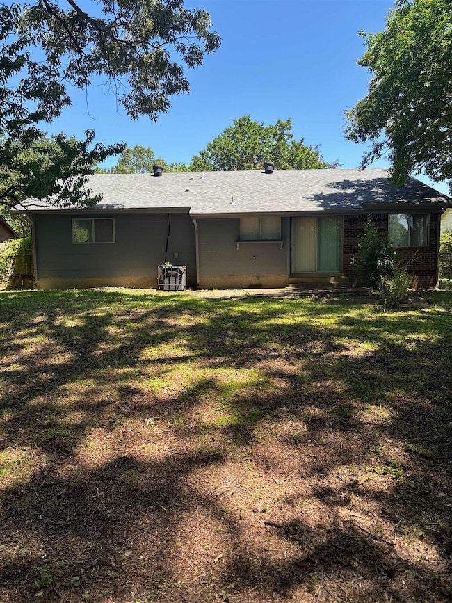 Back of property featuring a yard