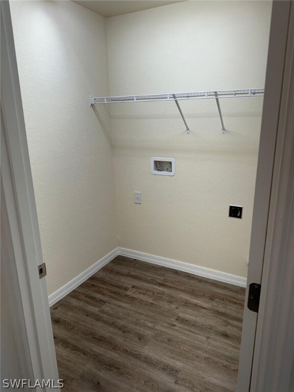 Clothes washing area featuring hookup for a washing machine, dark hardwood / wood-style flooring, and electric dryer hookup
