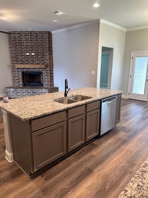 Kitchen with brick wall, a fireplace, dark hardwood / wood-style floors, sink, and dishwasher