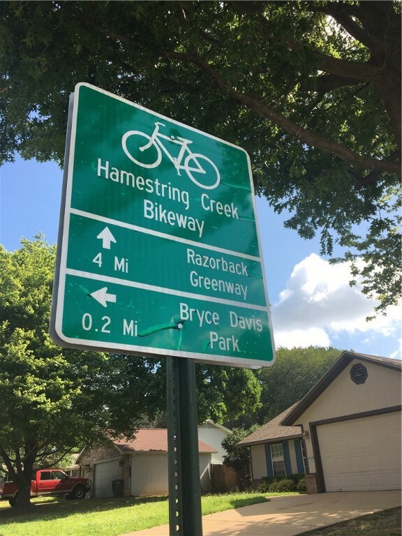 Sign posted on the street (house is in the background).