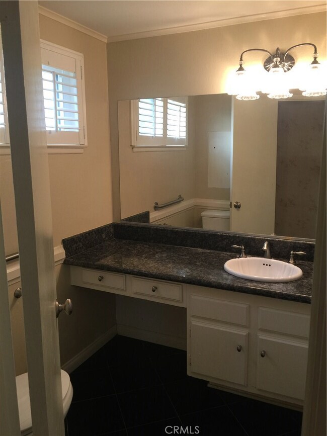Downstairs Half Bathroom With Granite Counter And Granite Tile Floor