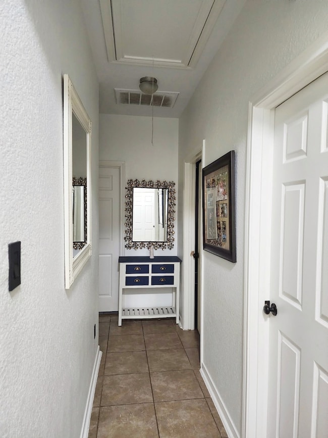 Hall to restroom, 2 bedrooms and laundry room.