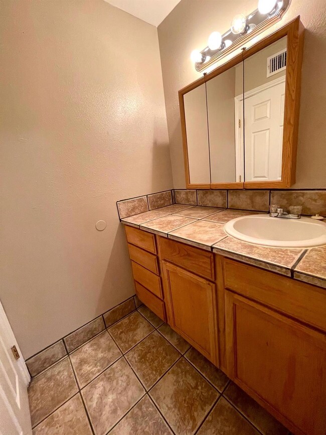 Bathroom with vanity and tile patterned floors