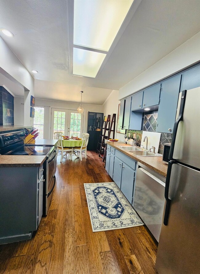 Kitchen featuring a sink, blue cabinets, stainles