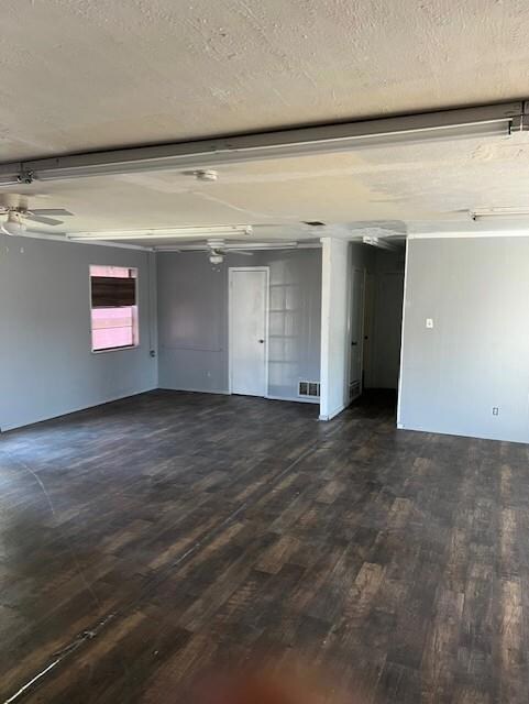 Garage with visible vents and a ceiling fan