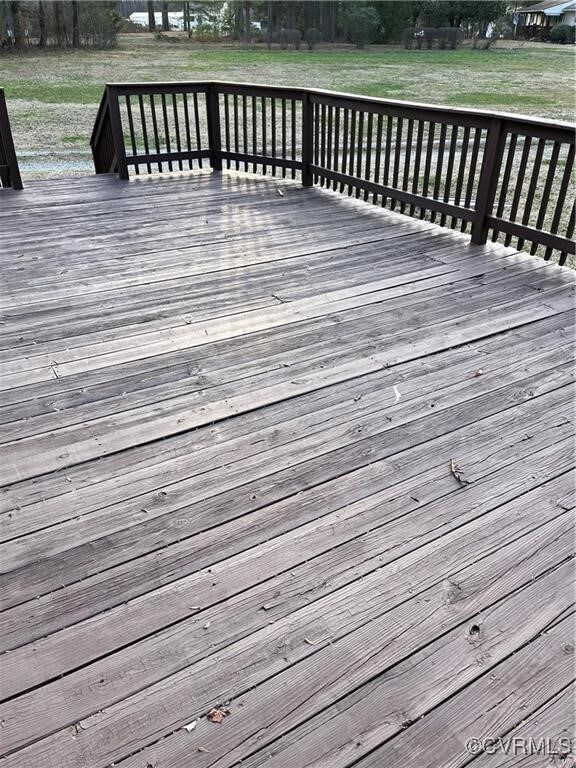 Wooden deck featuring a yard