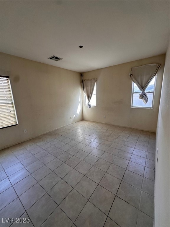 Unfurnished room with light tile patterned floors