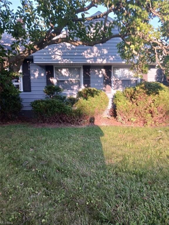 View of home's exterior with a yard