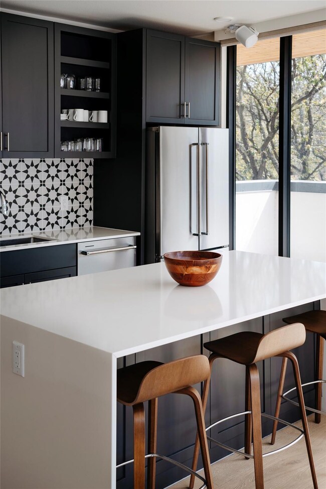 Kitchen featuring backsplash, light countertops, 