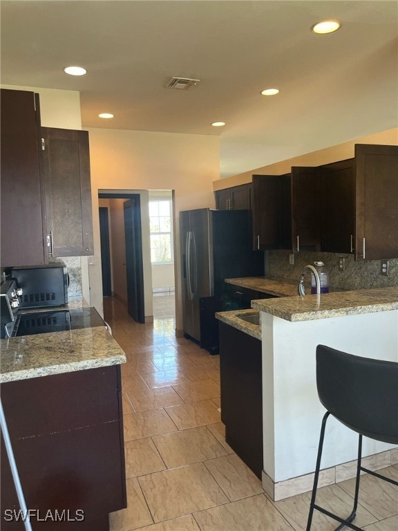 Kitchen featuring a peninsula, tasteful backsplash