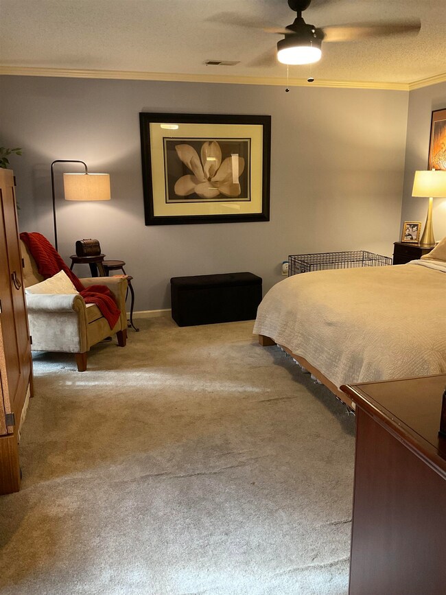 Bedroom featuring carpet floors, a textured ceilin