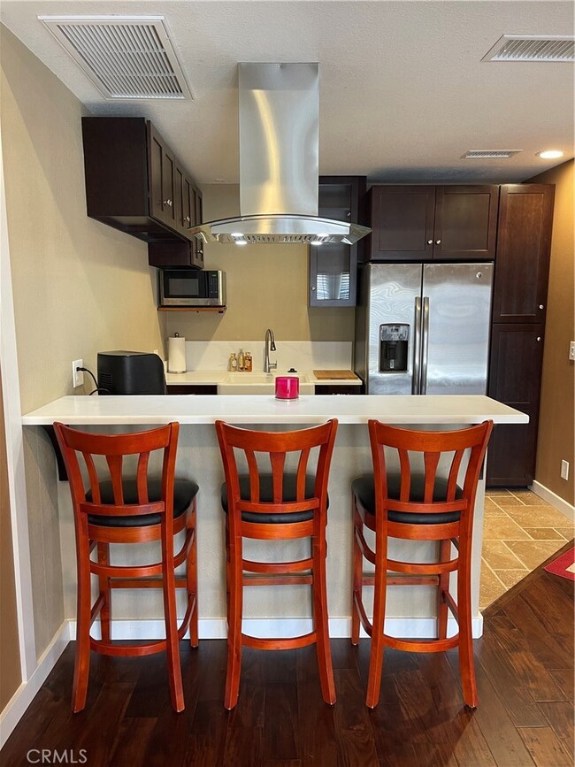 Kitchen with Bar Area seating with 3 barstools