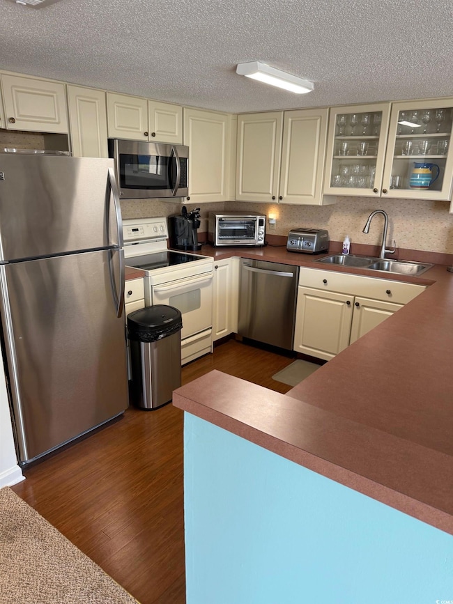 Kitchen with glass insert cabinets, dark wood-styl