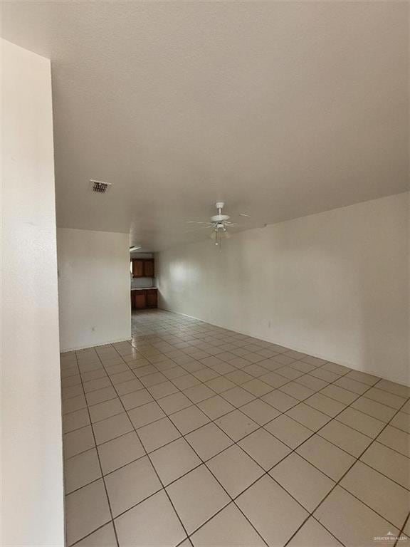 Spare room with ceiling fan and light tile patterned flooring