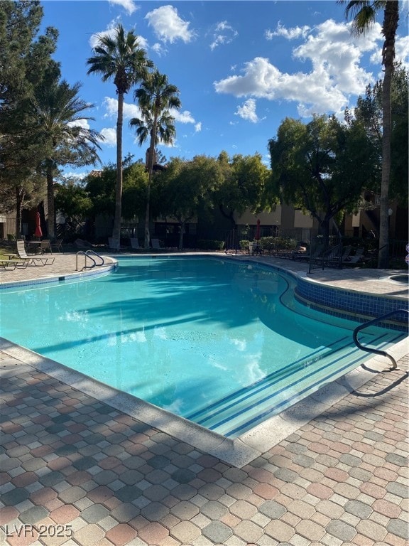 Community pool featuring a patio