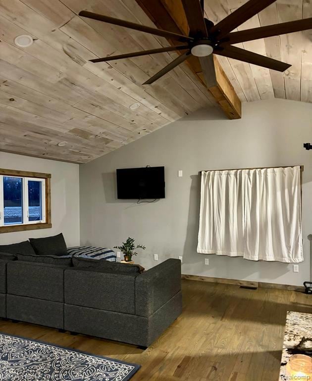 Living room featuring wood ceiling, wood finished floors, and ceiling fan