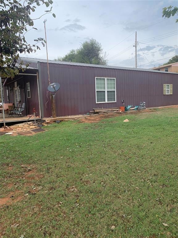View of grassy yard with a deck