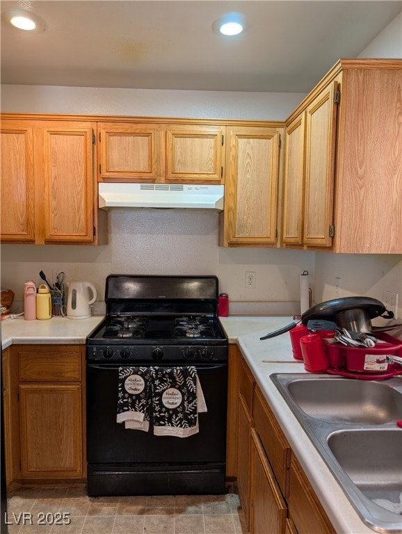 Kitchen with black gas range, under cabinet range