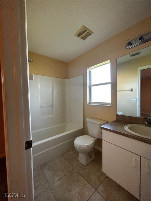 Bathroom with vanity, bathtub / shower combination, and light tile patterned floors