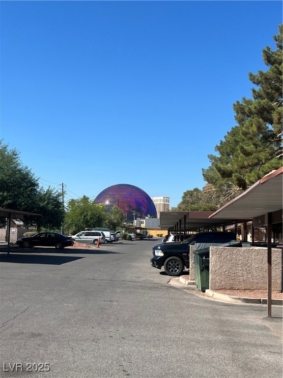 View of parking featuring a carport