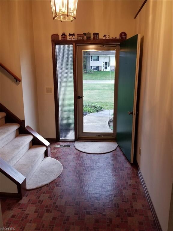 Front entryway, steps going up and down on the lef