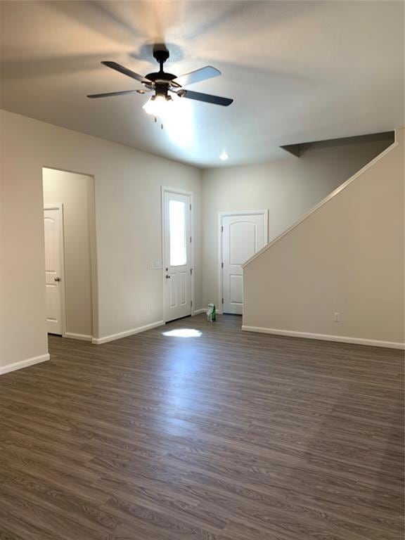 Unfurnished living room with ceiling fan, baseboar