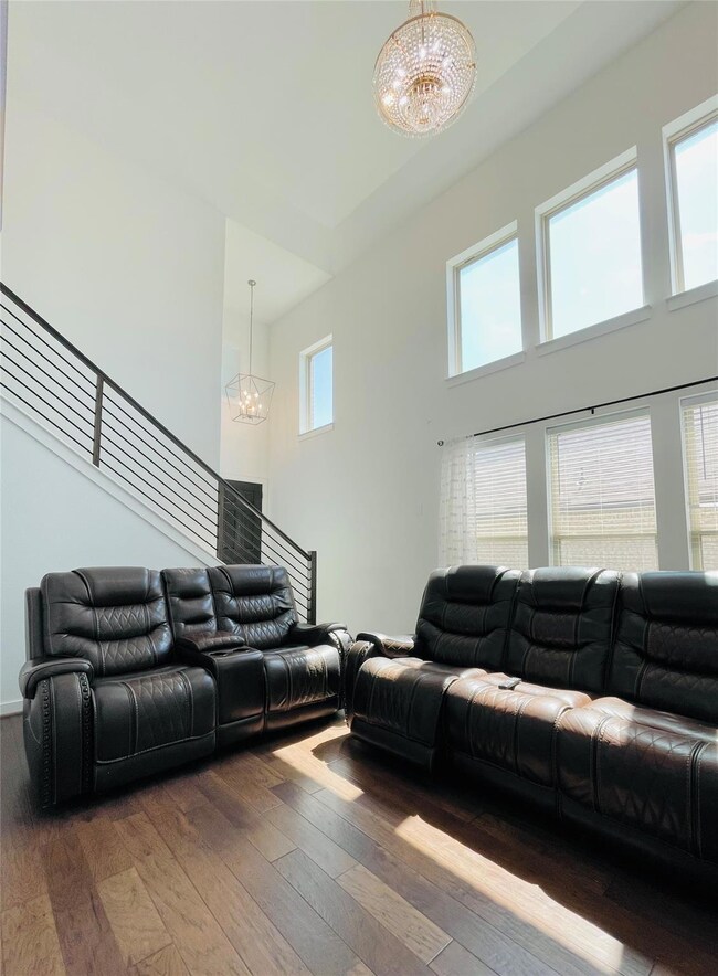 Living area featuring a chandelier, a towering ce
