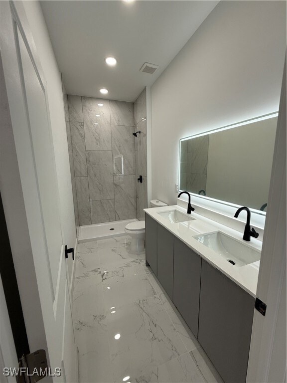 Bathroom featuring marble finish floors, recessed