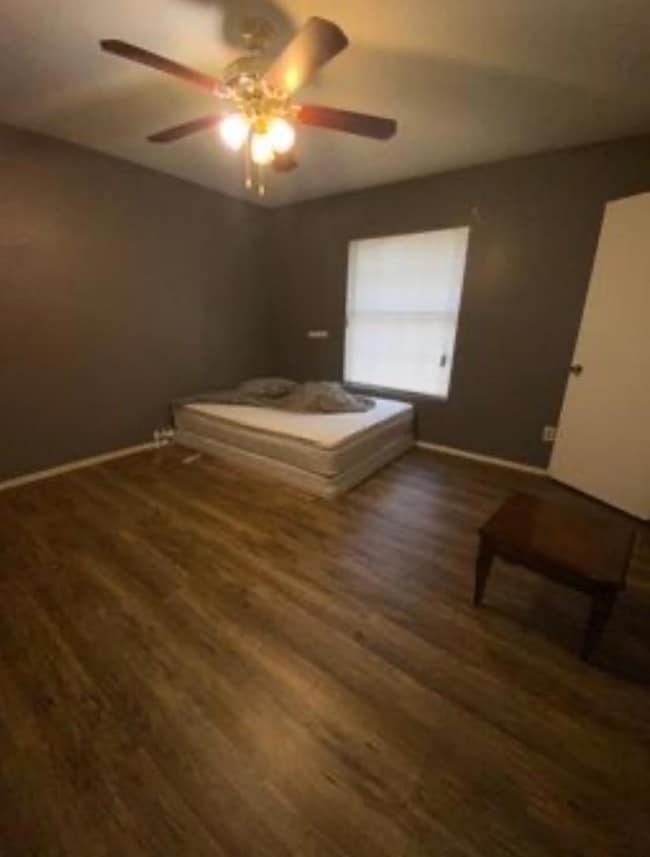 Unfurnished bedroom featuring dark wood-type floor