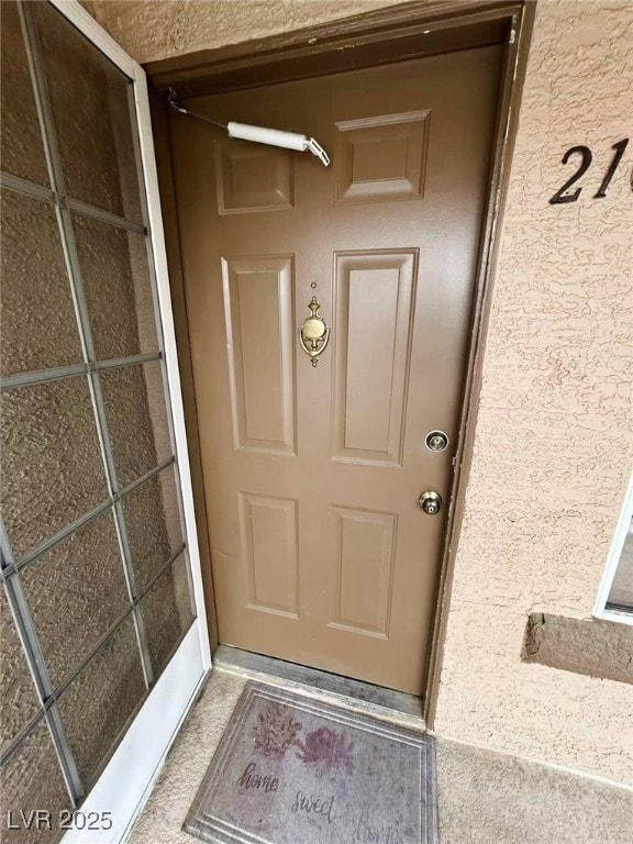 Property entrance with stucco siding